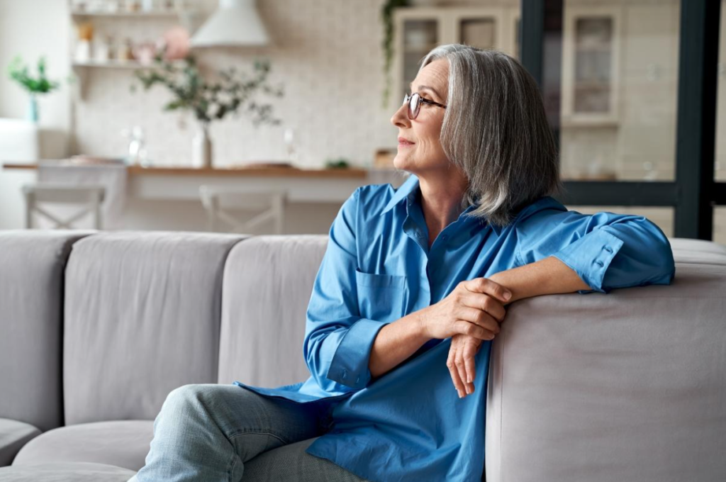 A woman on the couch looking away.